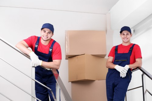 Mover wearing PPE while carrying household items